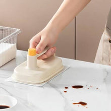 Magic cleaning brush cleaning a glass shower door